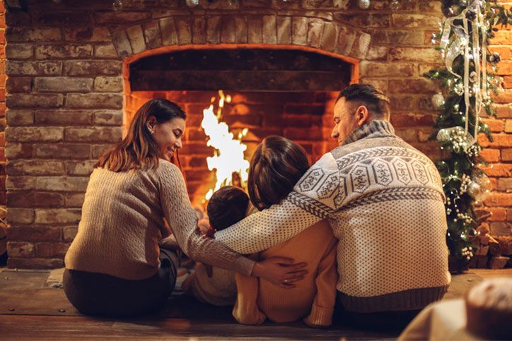 a family sitting by a fire